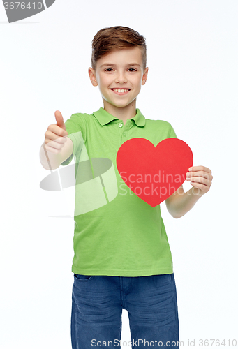 Image of happy boy showing red heart shape and thumbs up