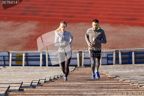 Image of couple running upstairs on stadium