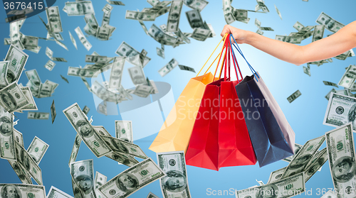 Image of close up of female hand holding shopping bags