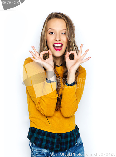 Image of happy young woman or teen showing ok hand sign