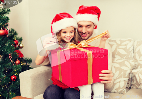 Image of smiling father and daughter opening gift box