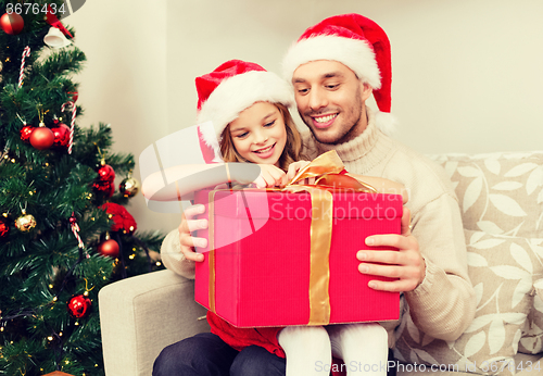 Image of smiling father and daughter opening gift box