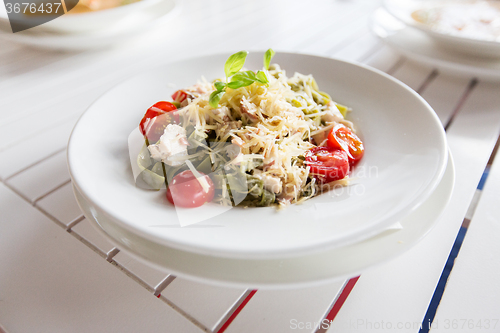 Image of close up of pasta with tomato and cheese on plate