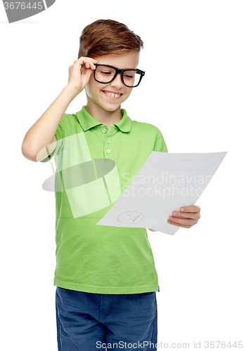 Image of happy boy in eyeglasses holding school test result