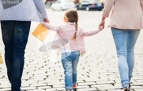 Image of close up of family with child shopping in city