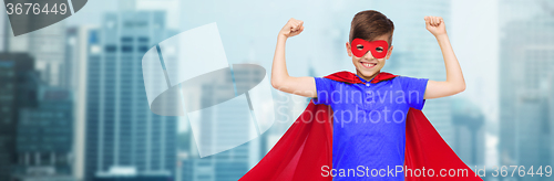Image of boy in red super hero cape and mask showing fists