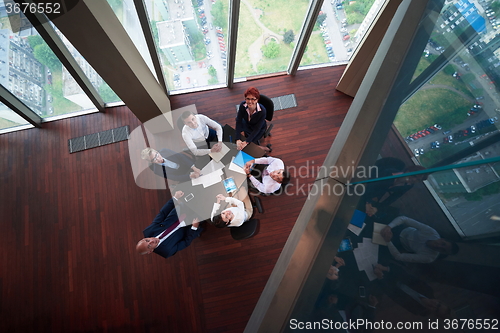 Image of top view of business people group throwing dociments in air