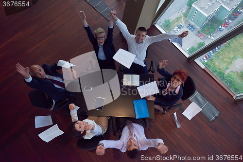Image of top view of business people group throwing dociments in air