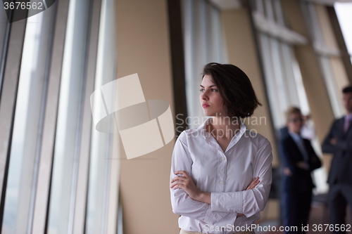 Image of business people group, woman in front  as team leader