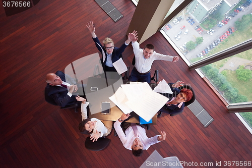 Image of top view of business people group throwing dociments in air