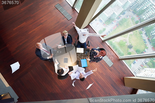 Image of top view of business people group throwing dociments in air
