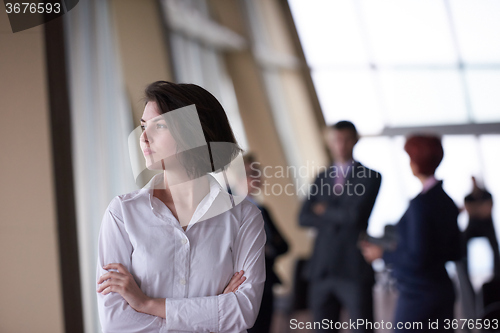 Image of business people group, woman in front  as team leader