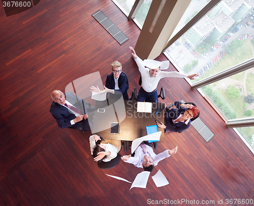 Image of top view of business people group throwing dociments in air