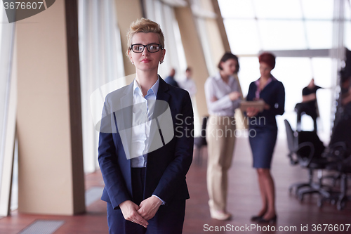 Image of business people group, woman in front  as team leader