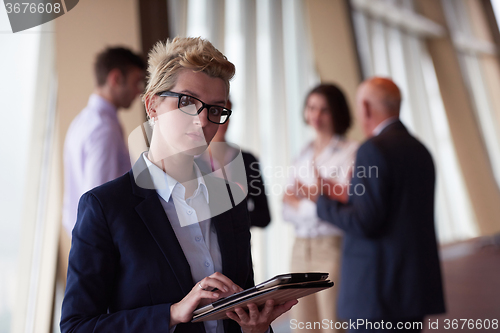 Image of diverse business people group with blonde  woman in front