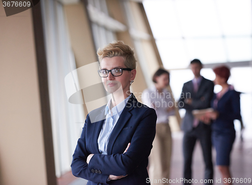 Image of business people group, woman in front  as team leader