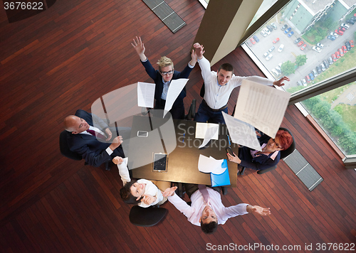 Image of top view of business people group throwing dociments in air