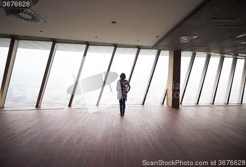 Image of young successful woman in penthouse apartment