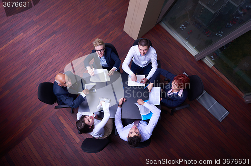 Image of top view of business people group throwing dociments in air