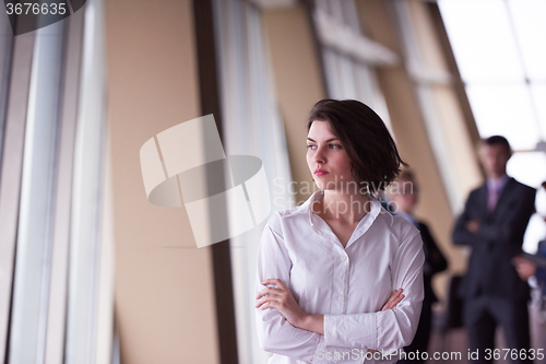 Image of business people group, woman in front  as team leader