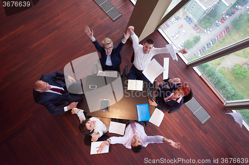 Image of top view of business people group throwing dociments in air