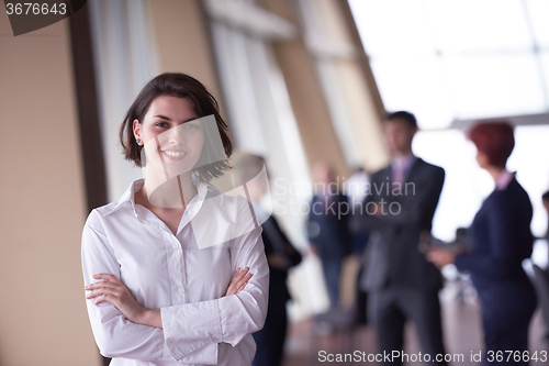 Image of business people group, woman in front  as team leader