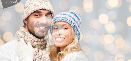 Image of smiling couple in winter clothes hugging