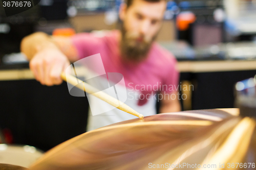 Image of close up of male musician playing cymbals