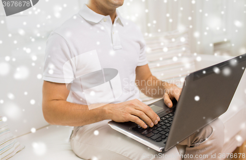 Image of close up of man working with laptop at home