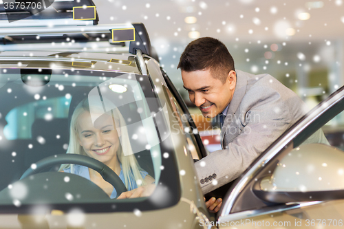 Image of happy woman with car dealer in auto show or salon