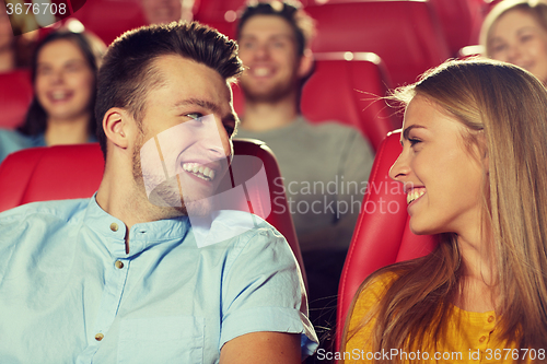 Image of happy friends watching movie in theater