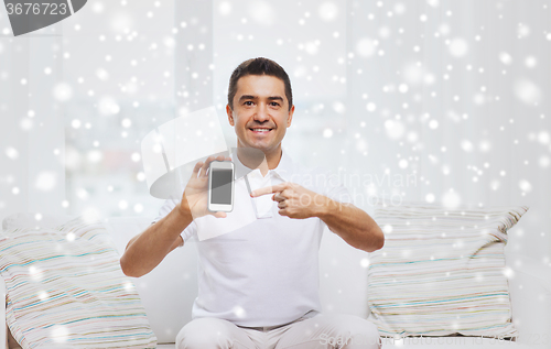 Image of happy man with smartphone at home