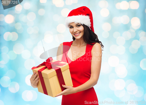 Image of beautiful sexy woman in santa hat with gift box