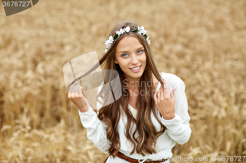 Image of smiling young hippie woman on cereal field