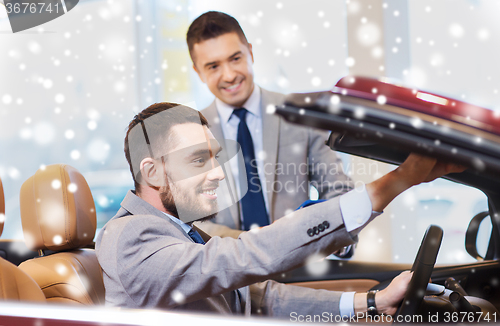 Image of happy man with car dealer in auto show or salon