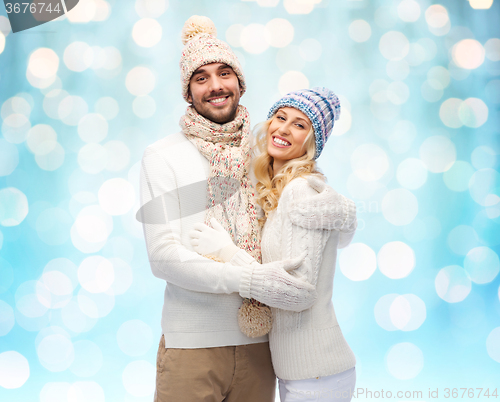 Image of smiling couple in winter clothes hugging