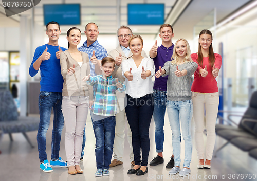 Image of group of smiling people showing thumbs up