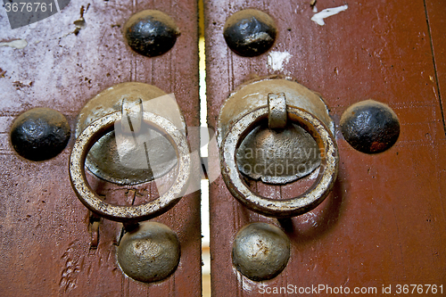 Image of   in africa the old wood  facade  and rusty safe padlock 