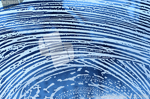 Image of Abstract lines of natural soap foam on the glass