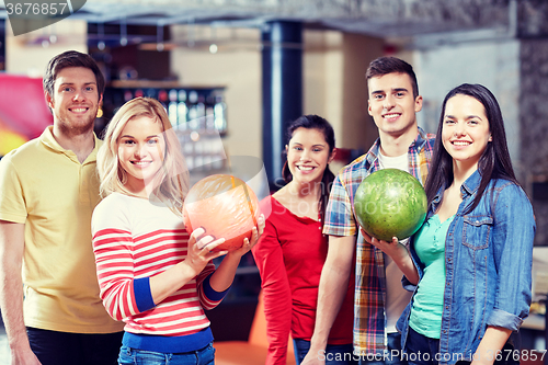 Image of happy friends in bowling club