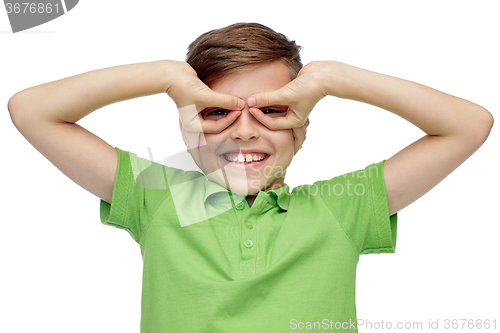 Image of happy boy in t-shirt having fun and making faces