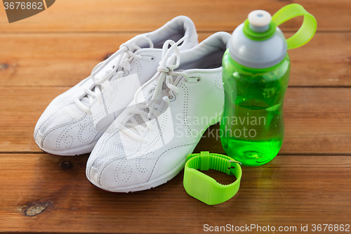 Image of close up of sneakers, bracelet and water bottle