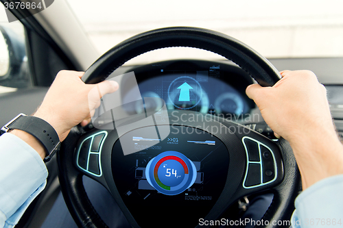 Image of close up of man driving car with volume level icon