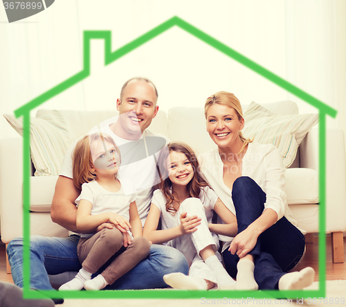Image of smiling parents and two little girls at new home