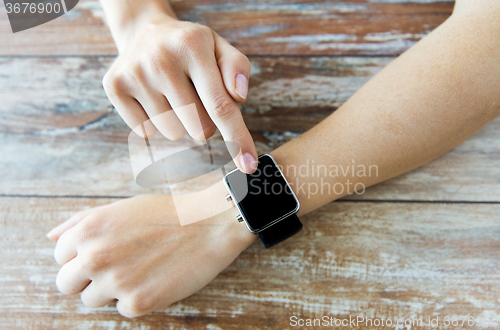 Image of close up of hands setting smart watch