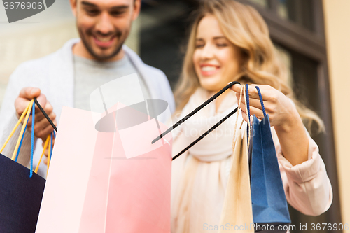 Image of close up of couple with shopping bags on street
