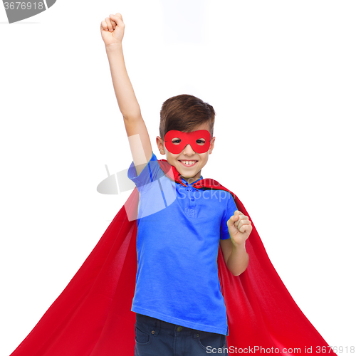 Image of boy in red super hero cape and mask showing fists