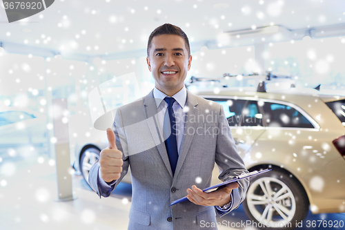 Image of happy man at auto show or car salon