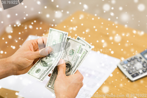 Image of close up of man hands counting money at home