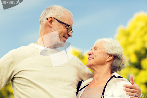 Image of senior couple hugging in city park